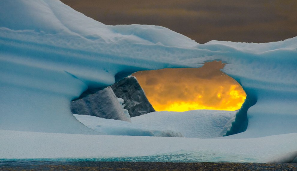 Sunset through a hole in an iceberg
